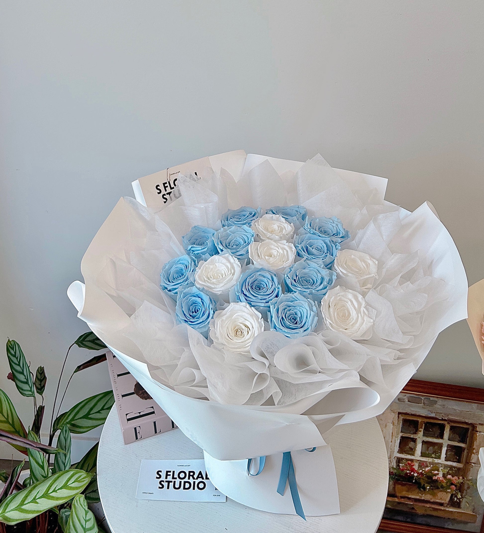 Preserved blue and white roses bouquet
